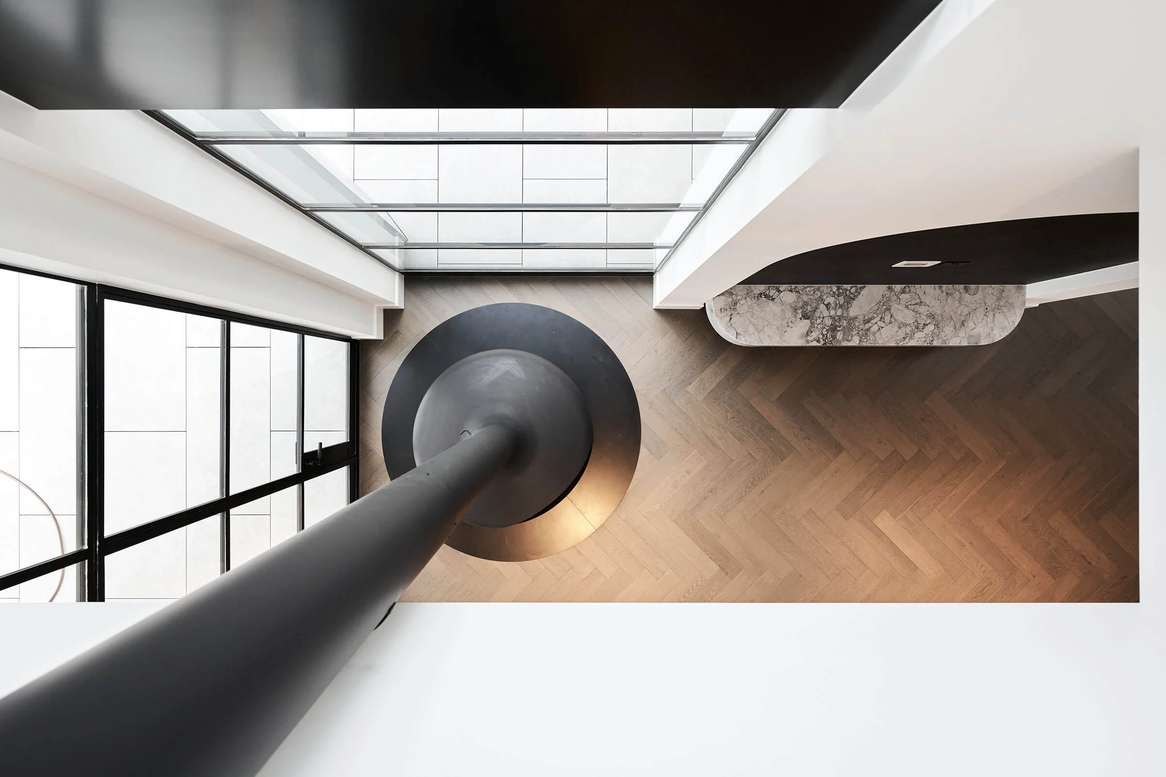 Hawthorn, looking down through the central void to the curved stair and herringbone floor