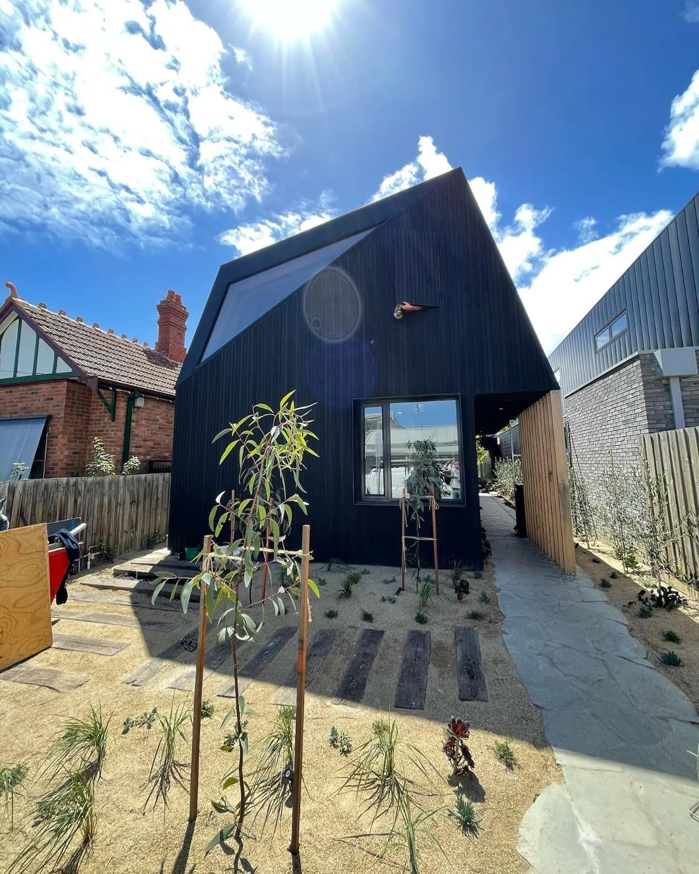 Windsor completed black-clad residence with angular roof and side entrance